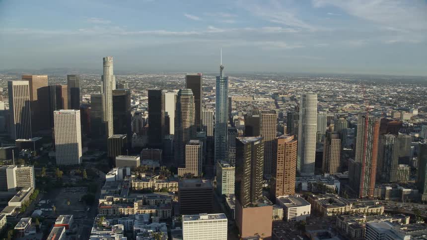 Aerial footage captures the impressive skyscrapers towering over downtown Los Angeles on a sunny day