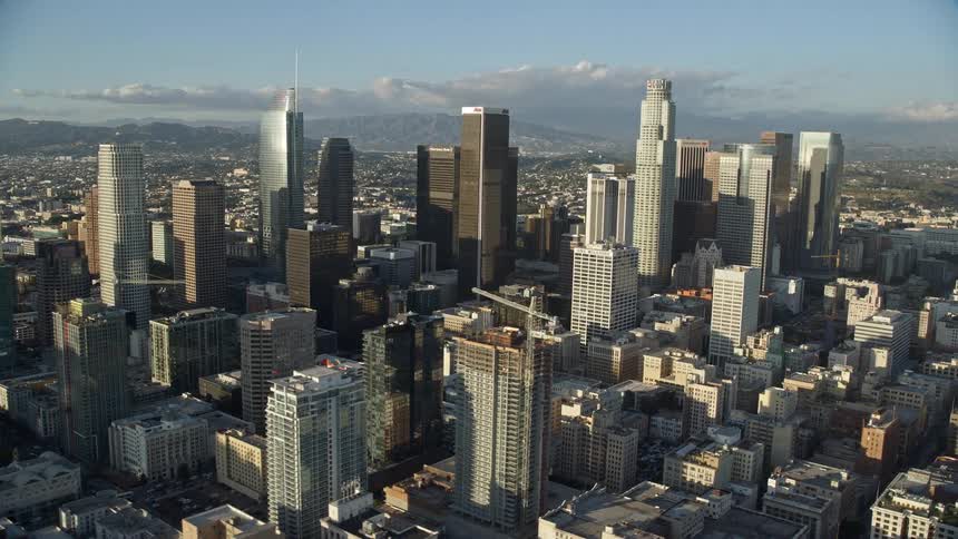 A stunning aerial view of Oceanwide Plaza and tall skyscrapers in Downtown Los Angeles California captured during a partly cloudy day