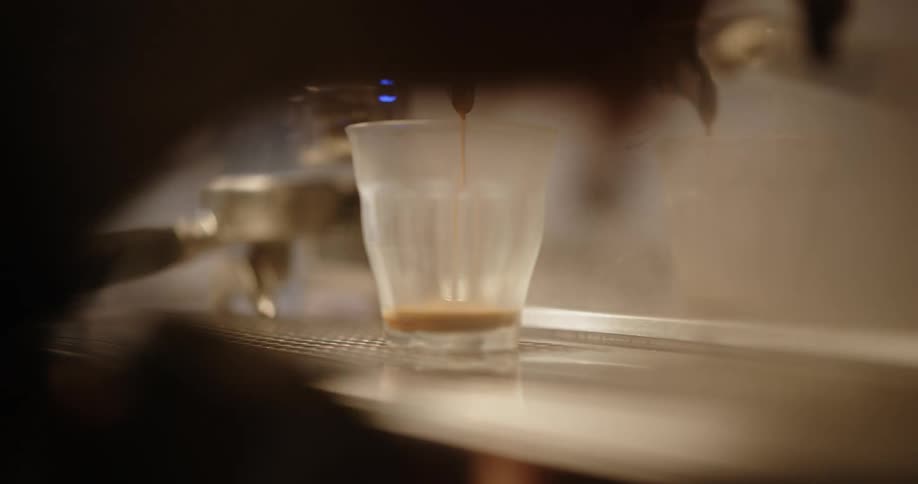 Close up of expresso pouring into a glass in a cafe