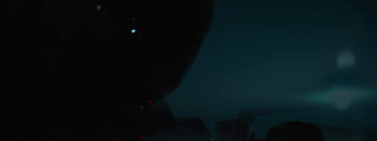 A woman rides her motorcycle at night