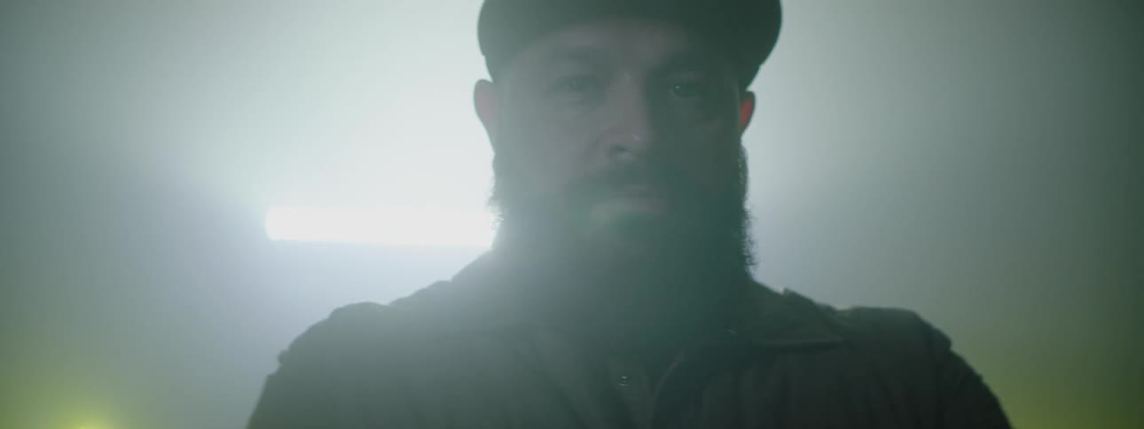 A man is standing in front of his truck