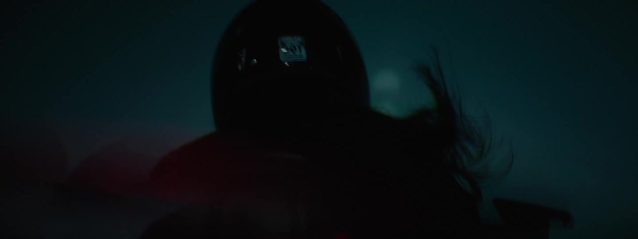 A woman is riding a motorcycle