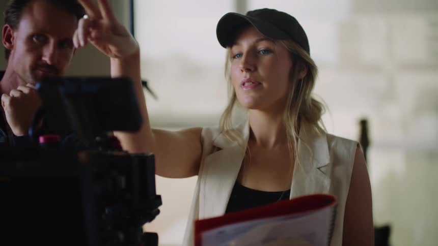 Two people using a camera on a set