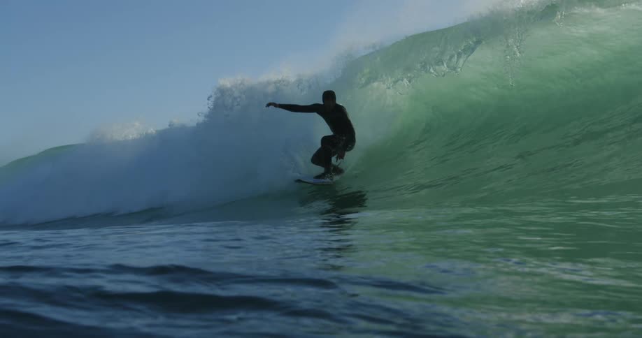 A man rides a large ocean wave