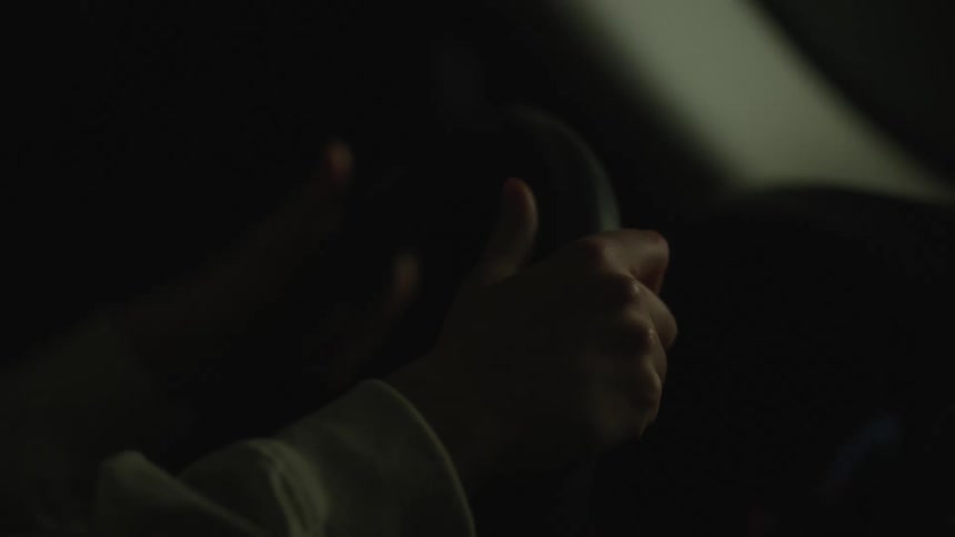 Nighttime driving hands on a steering wheel