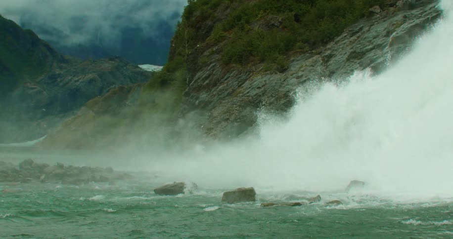 Landscape of waterfall cascading down mountainside