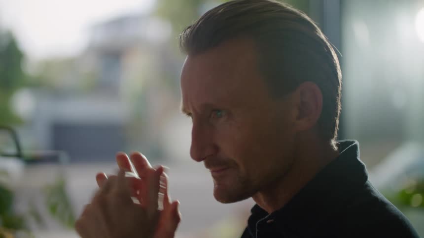 A man is smiling while looking at something