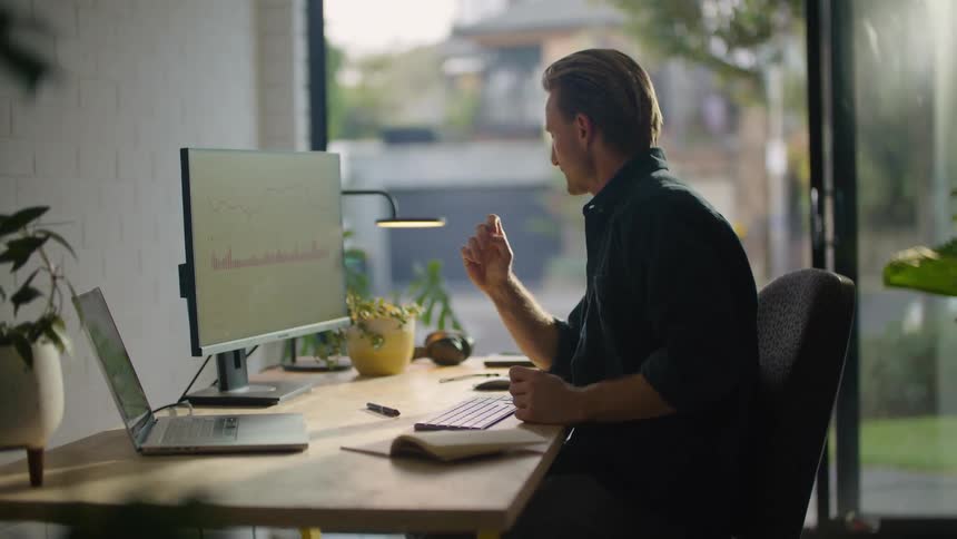 A man using a computer in a room