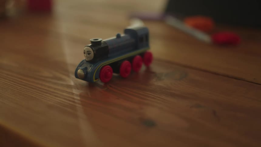 A small toy train on a wooden table