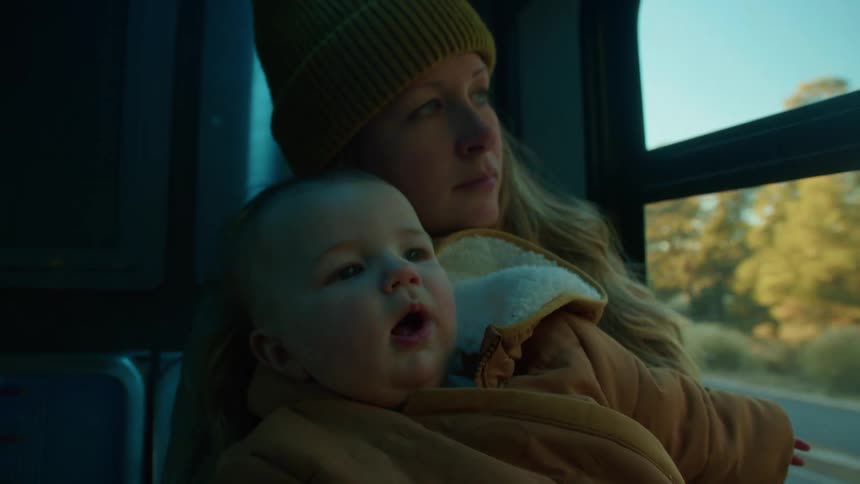 A mother and her baby riding on a bus
