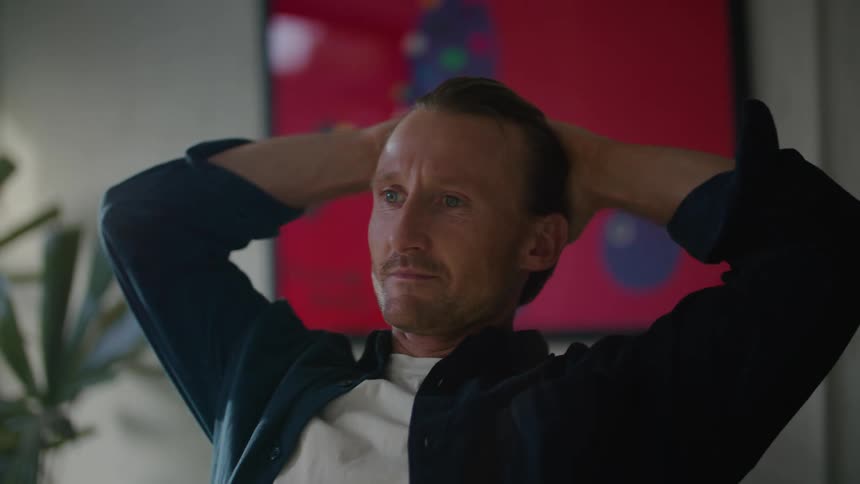 Very confident man leans back in his office chair looking very pleased boss probably conducting an interview