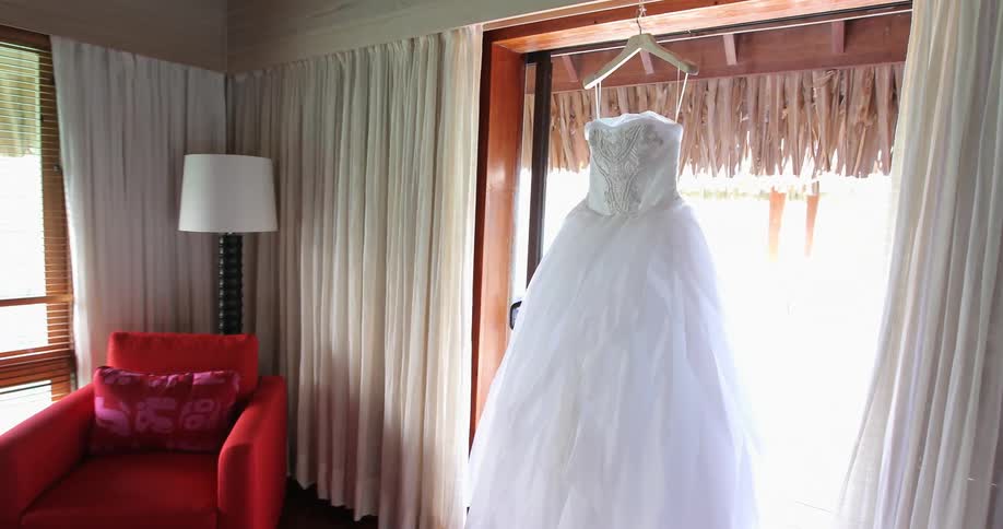 Bridal gown hanging in a doorway