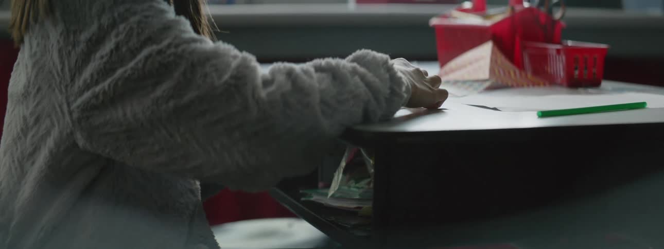 A person sitting at a desk folding paper into shapes