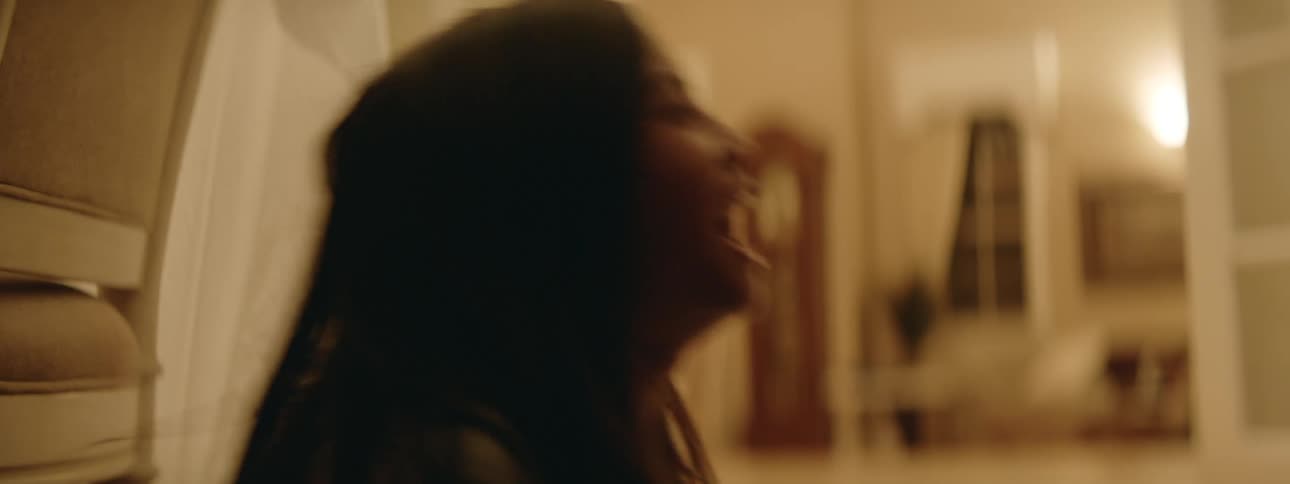 A mother and daughter play rock paper scissors in their home living room at night