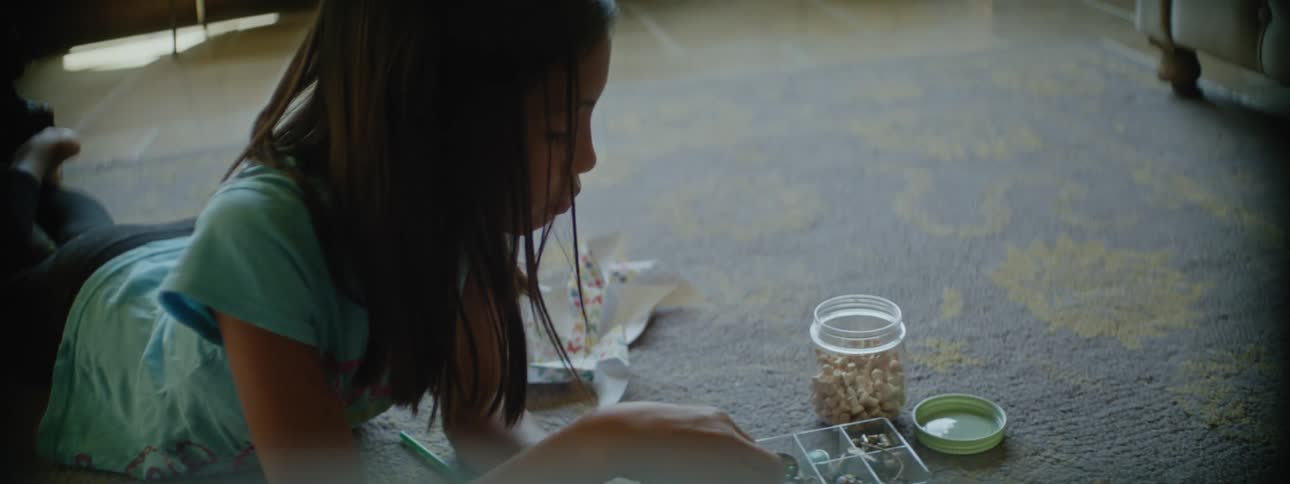 A child is sorting through a small box