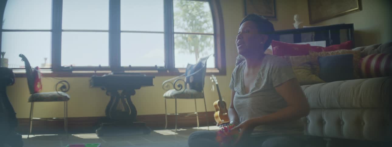 Mother and daughter playing with an expandable ball in the living room at home