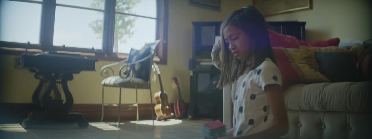 Mother and daughter are sitting on the floor and hanging out indoors