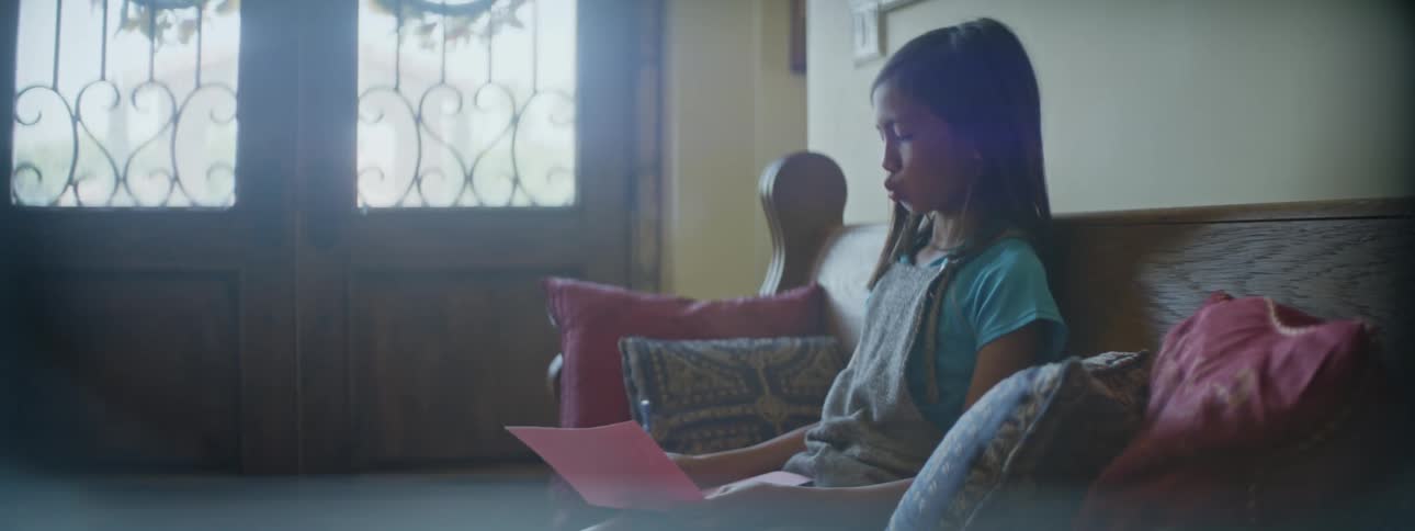 A child is writing with a pen