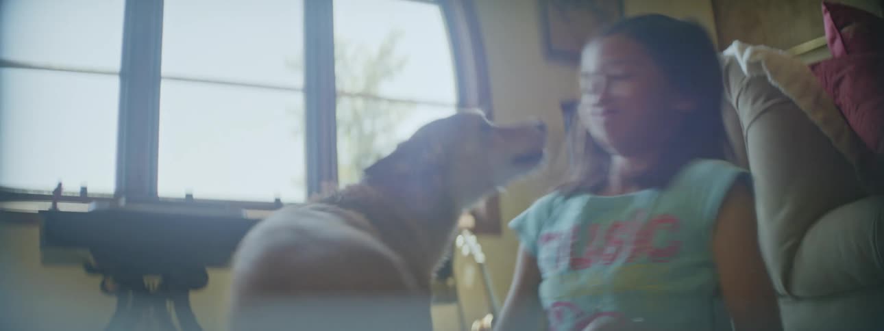 A girl plays with her dog