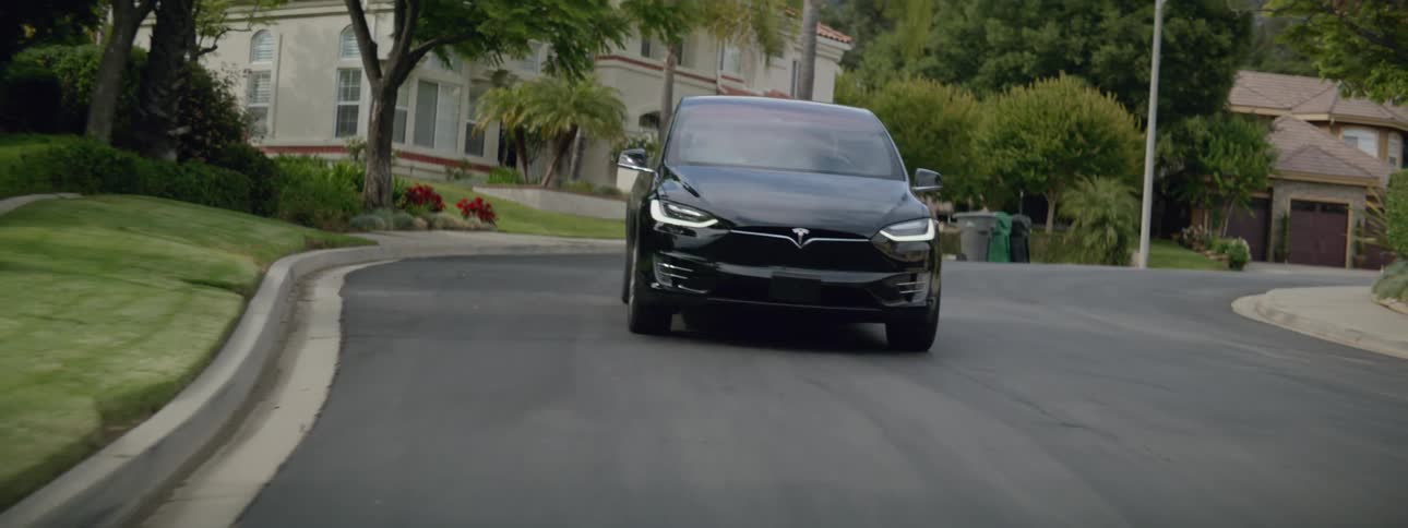 The car drives away from the home