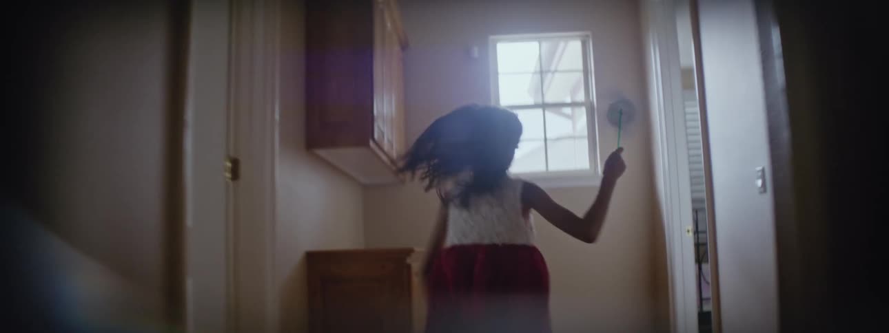 A girl runs through the house