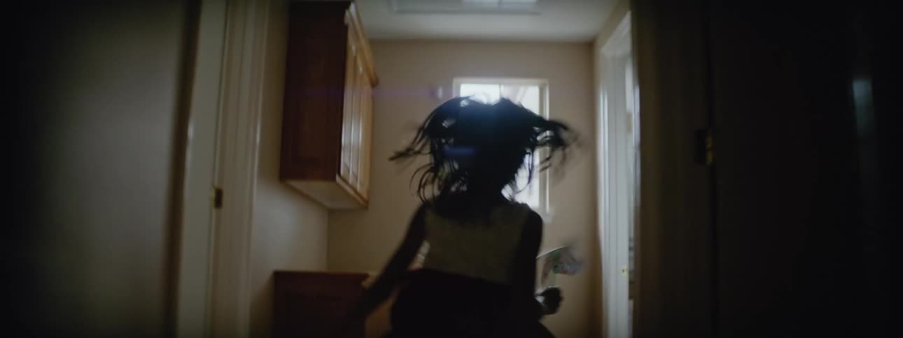 A girl runs down the hallway