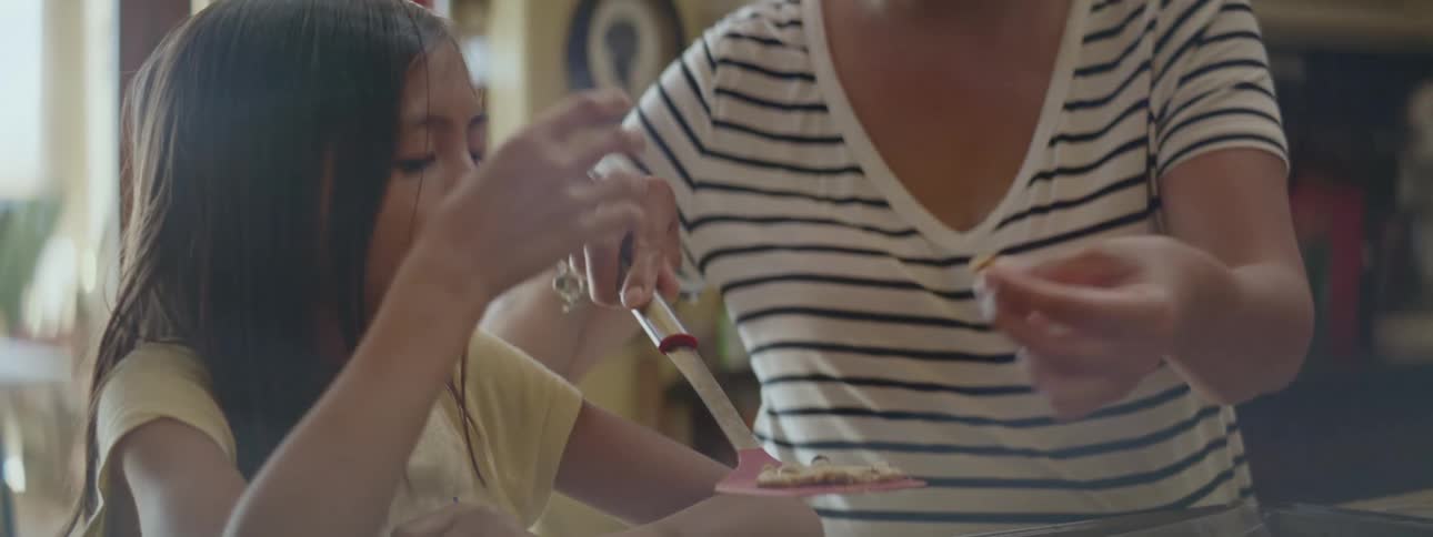 Mother and daugther taste raw cookie dough from homemade cookies in the kitchen at home