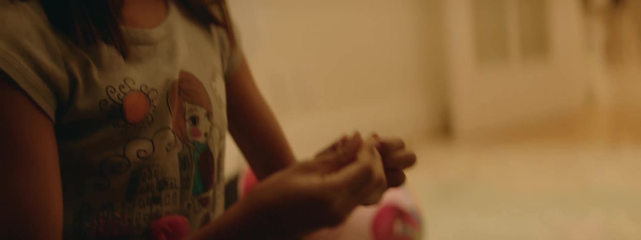 A child holds thread in her hands