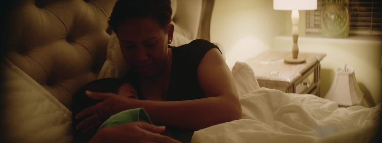 Mother and daughter are sleeping together in a bed