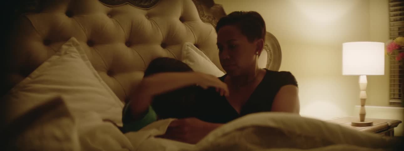 A girl runs into her moms bedroom and jumps in bed for a hug