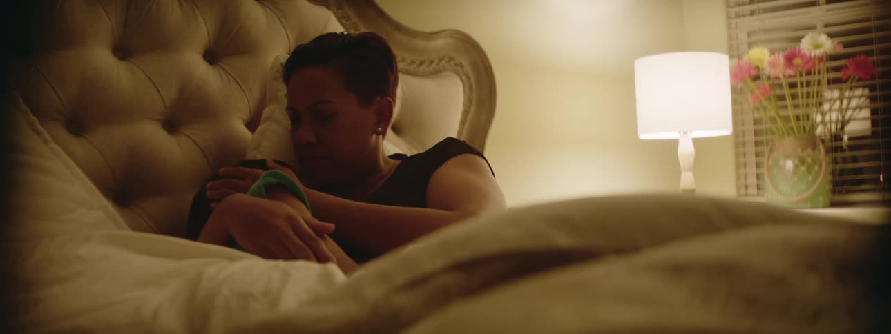 Mother and child are laying in the bed at night time