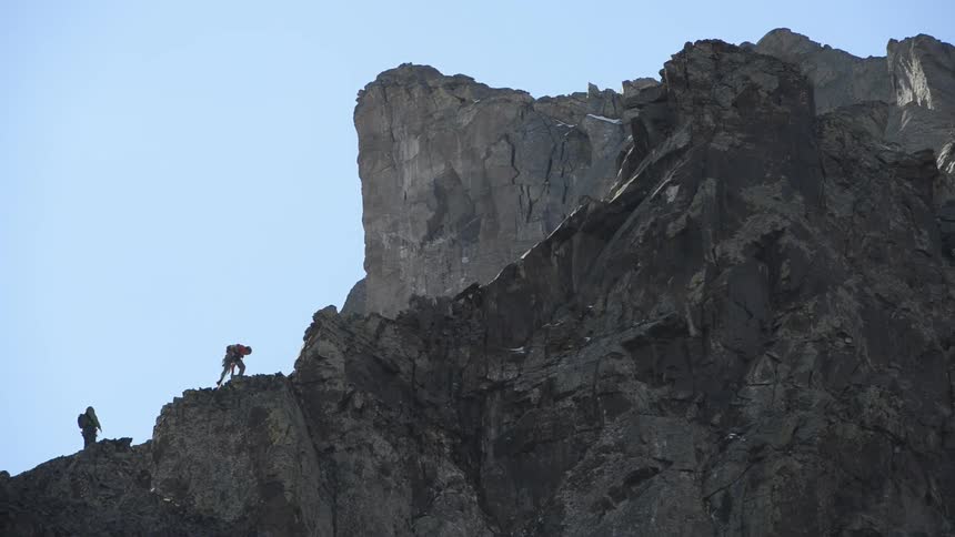 Two people are climbing the mountain