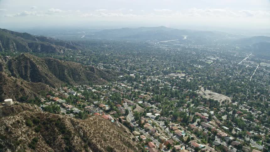  aerial footage captures the sunny and partly cloudy day as the camera flies over Tujungas beautiful residential neighborhoods in Southern California