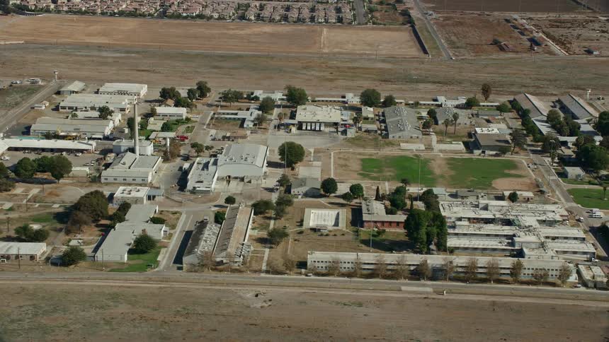 Aerial footage of the California Institution for Men in Chino California during a sunny day shot with a Shotover F1 camera in an orbit motion
