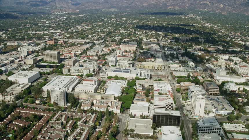 A breathtaking aerial view of Pasadena Californias bustling City Hall surrounded by office buildings and industrial areas shot during a partly cloudy day