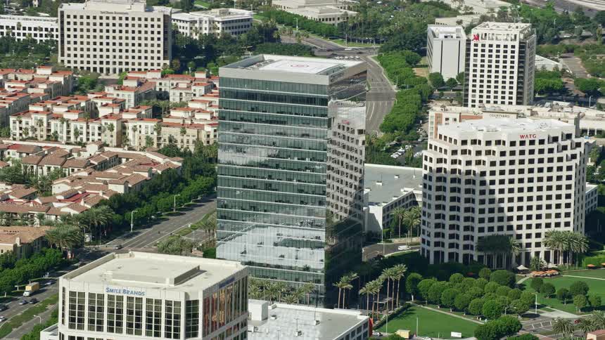 Aerial footage of an office building at Irvine Spectrum Center in Irvine California shot during a partly cloudy spring or summer day with an orbiting shot taken using a Shotover F1 camera on an Epic Helium drone