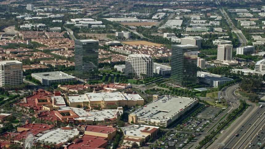 An epic aerial view of office and retail buildings at Irvine Spectrum Center California captured during a partly cloudy day