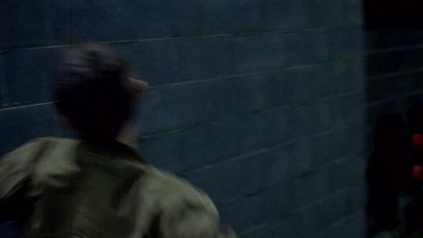 A man talking on his phone then smashing it against a wall and taking his skate board and doing the same before walking away in the alley