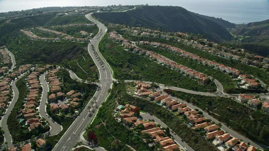 Aerial footage flying over hillside homes in Laguna Niguel California