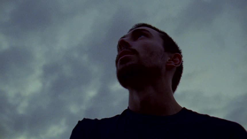 A man is looking around outside