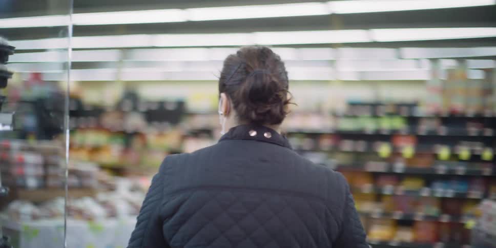 Female wearing medical face mask shopping at grocery store