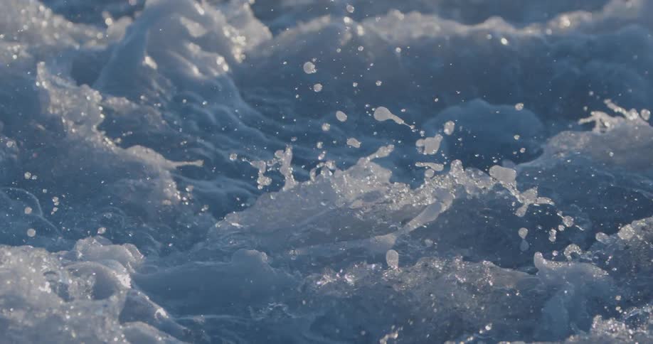 Water splashes and foams as it flows quickly