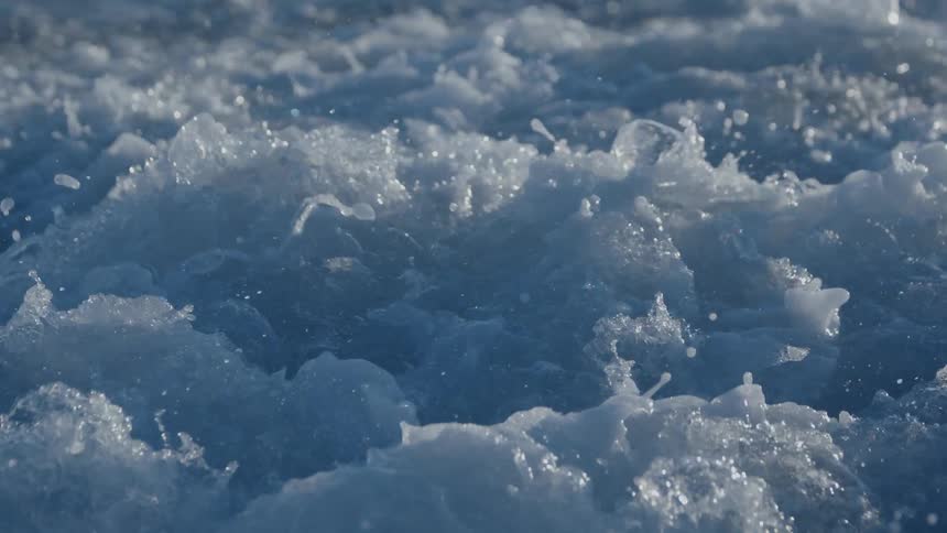 Close up of turbulent water foaming behind a boat at daytime