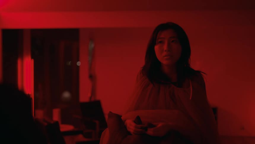 A woman is talking to someone inside of her home