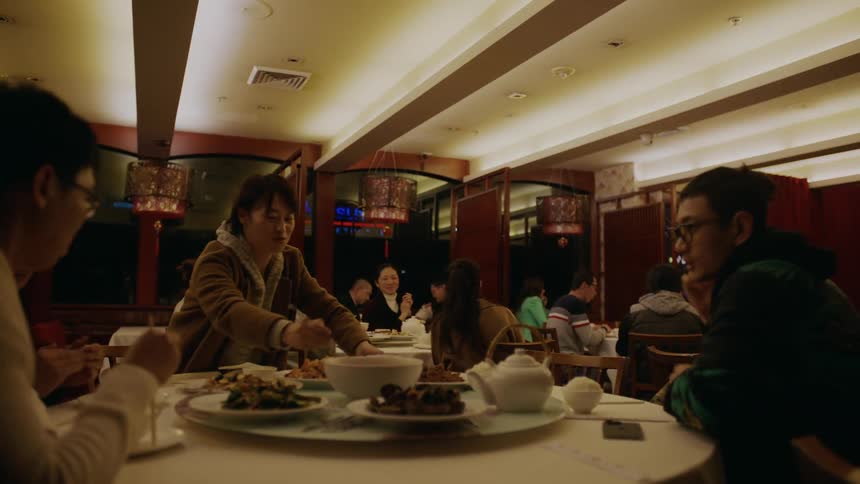 Group of people gathered at a restaurant give a round of applause after a show
