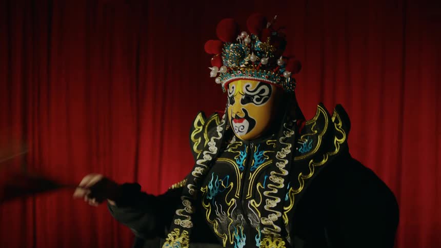 Actor performing bian lian chinese dramatic dance on stage