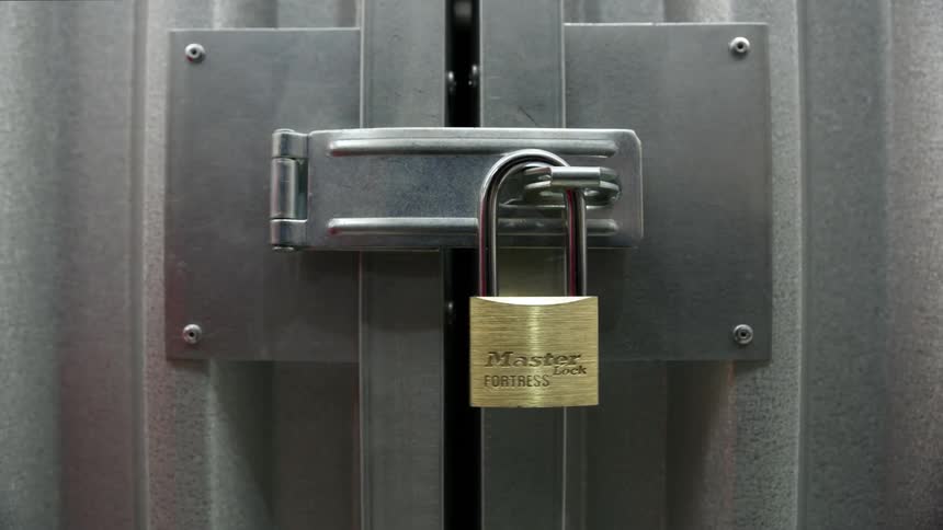 A person putting a lock on a door