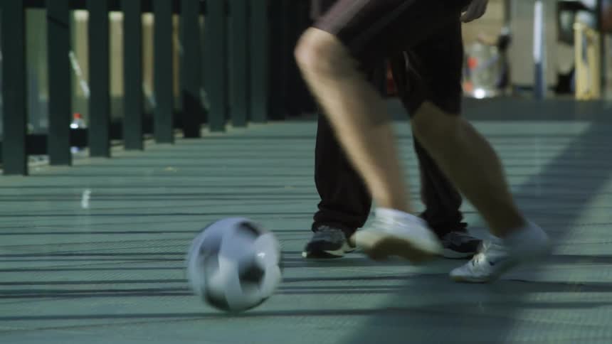 A group of friends playing soccer on bridge