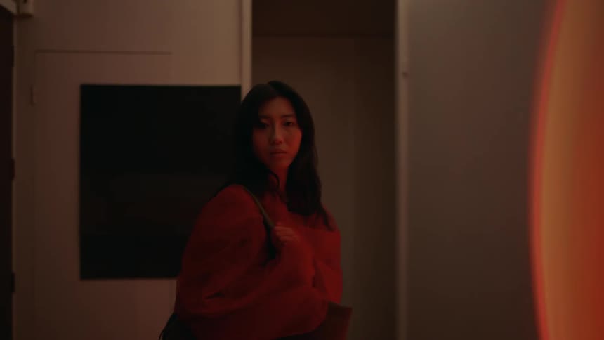 Young woman comes home alone to an eerie empty house at night hears something unexpected and turns around to investigate