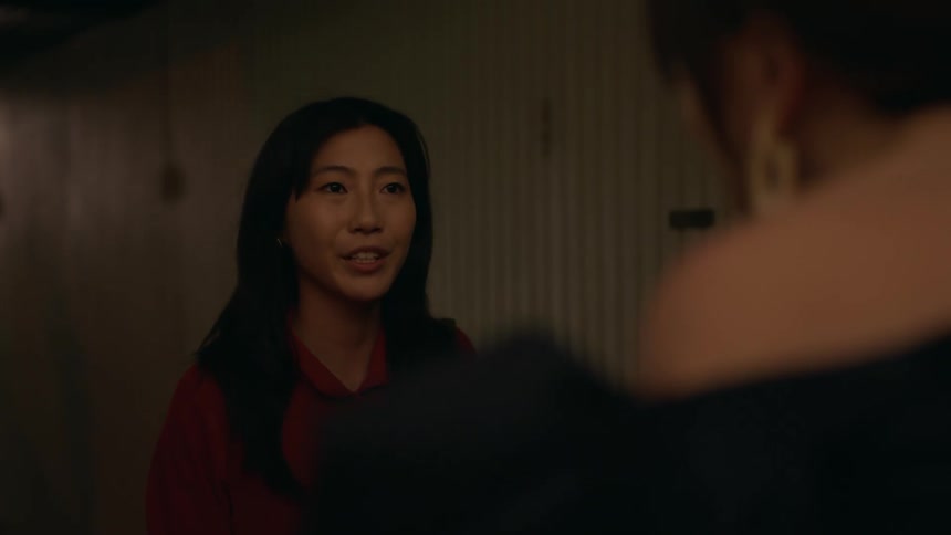 Woman wearing a luxury dress opens the door to receive a happy young woman